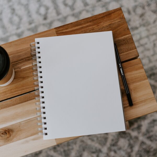 A blank piece of paper with a cup of coffee beside it.